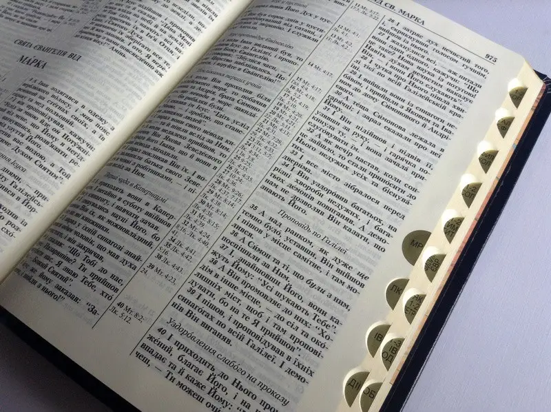 Open Ukrainian Bible with thumb index